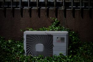 dirty condenser coil outdoor AC unit in San Diego backyard