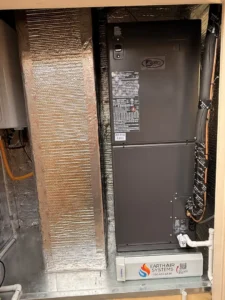 homeowner inspecting a clean HVAC air filter indoors, bright and comfortable home setting - how to maintain your heating and