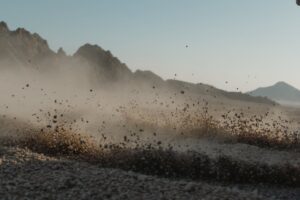 Santa Ana winds blowing dust across Southern California desert landscape near residential homes